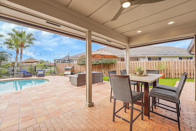 view of patio featuring a fenced in pool, grilling area, an outdoor hangout area, and ceiling fan