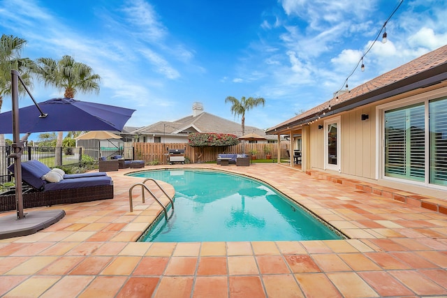 view of pool with an outdoor living space and a patio area