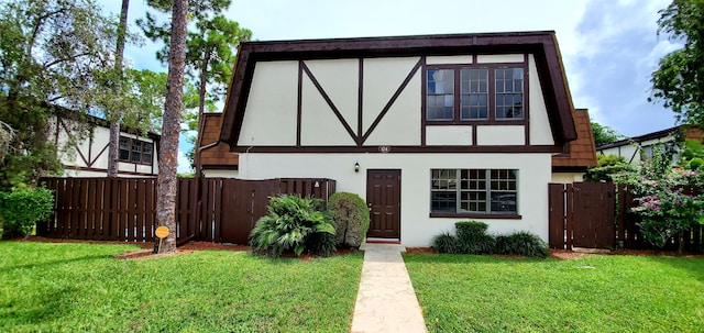 tudor-style house with a front lawn