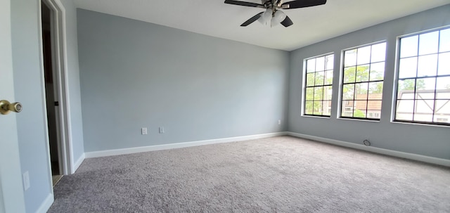 empty room featuring carpet floors and ceiling fan