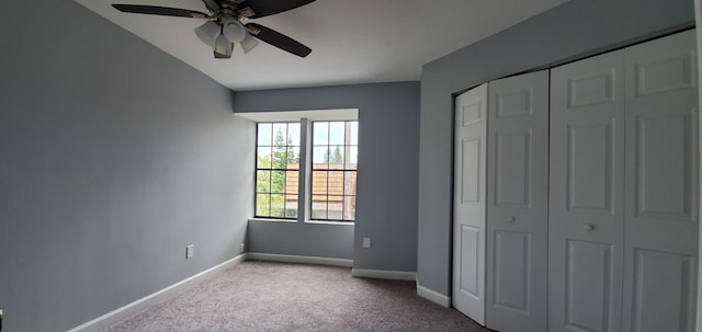 unfurnished bedroom featuring ceiling fan, a closet, and light carpet