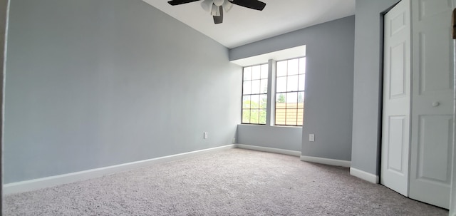 unfurnished bedroom with ceiling fan, light colored carpet, vaulted ceiling, and a closet