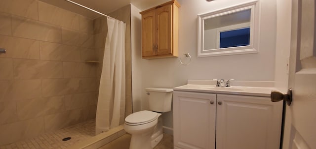 bathroom featuring toilet, vanity, and curtained shower