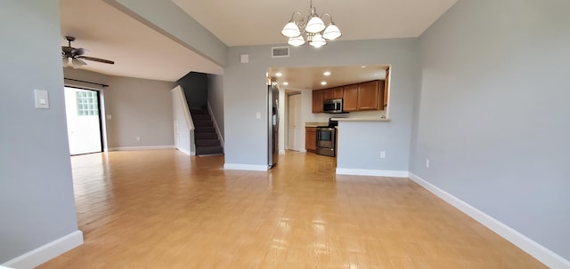 unfurnished living room with ceiling fan with notable chandelier and light hardwood / wood-style flooring