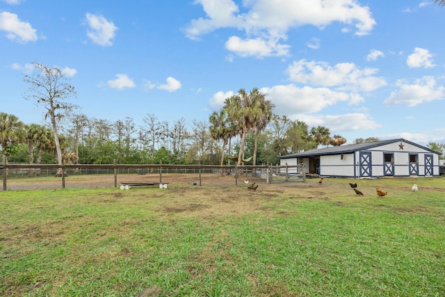 view of yard with an outdoor structure and a rural view