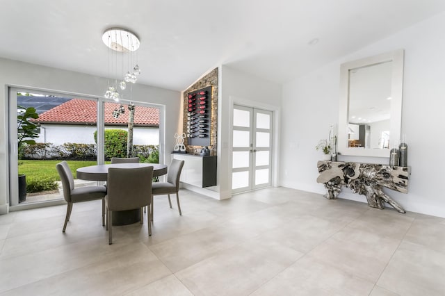 dining area featuring vaulted ceiling