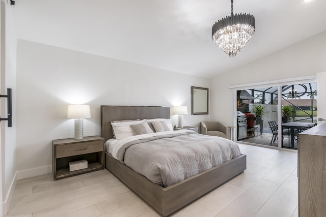 bedroom featuring a chandelier, vaulted ceiling, and access to outside