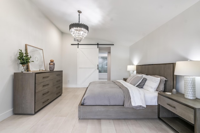 bedroom with an inviting chandelier and a barn door