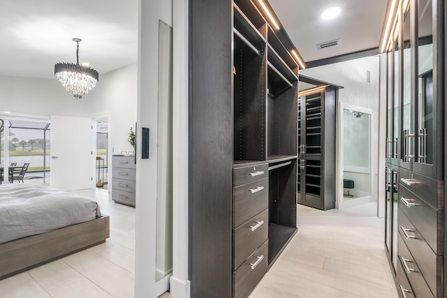 walk in closet featuring an inviting chandelier