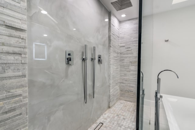 bathroom featuring tiled shower and tile patterned floors