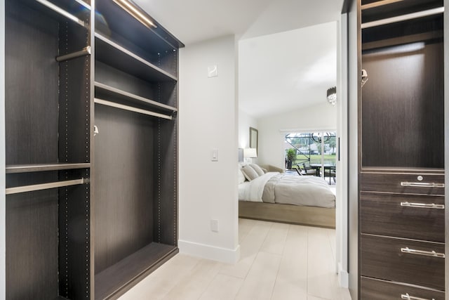 walk in closet featuring vaulted ceiling