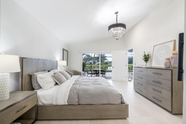 bedroom with access to exterior, vaulted ceiling, and a notable chandelier