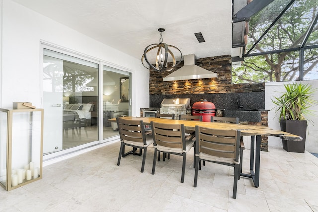 view of patio / terrace with a grill, a lanai, and exterior kitchen