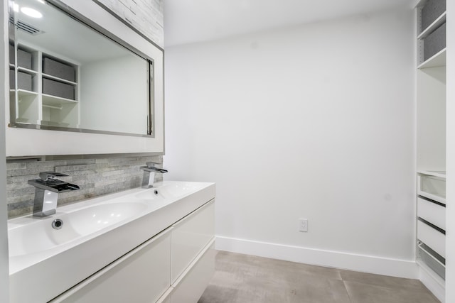 bathroom with vanity and decorative backsplash