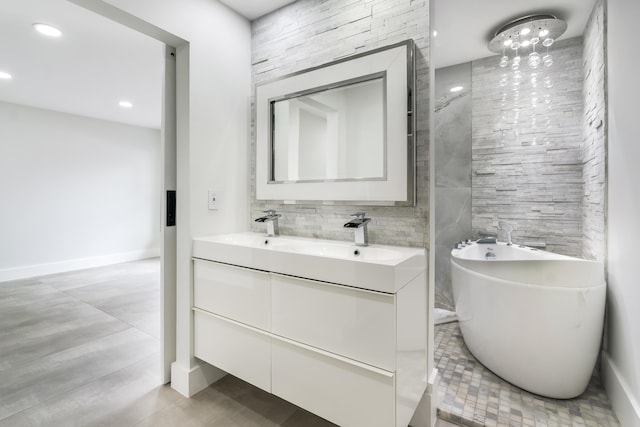 bathroom with a washtub and vanity