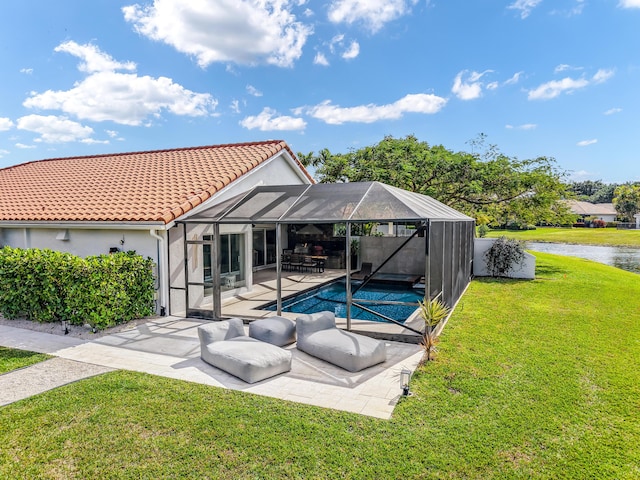 view of swimming pool featuring a yard, a lanai, a patio area, and a water view