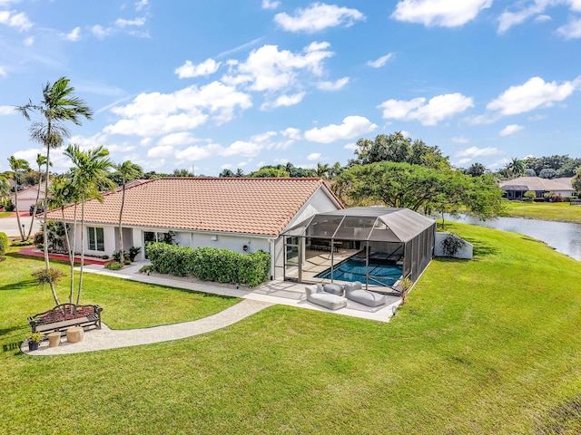 back of property featuring a lanai, a lawn, a patio area, and a water view