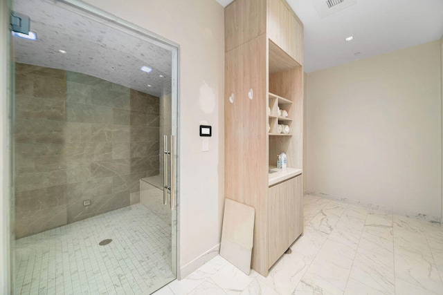 bathroom with a tile shower