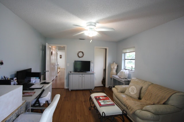 living room featuring a textured ceiling, ceiling fan, and dark hardwood / wood-style flooring