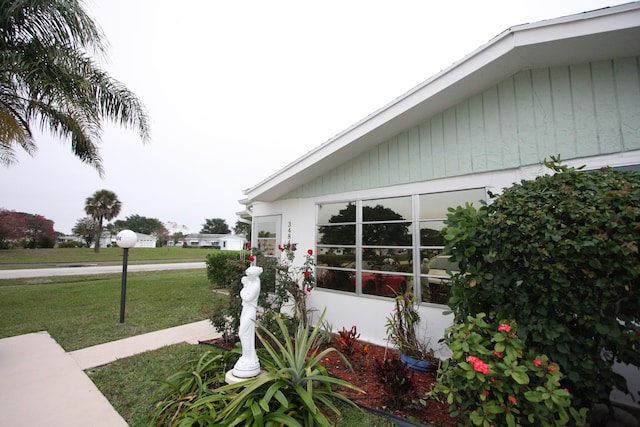 view of side of property with a yard