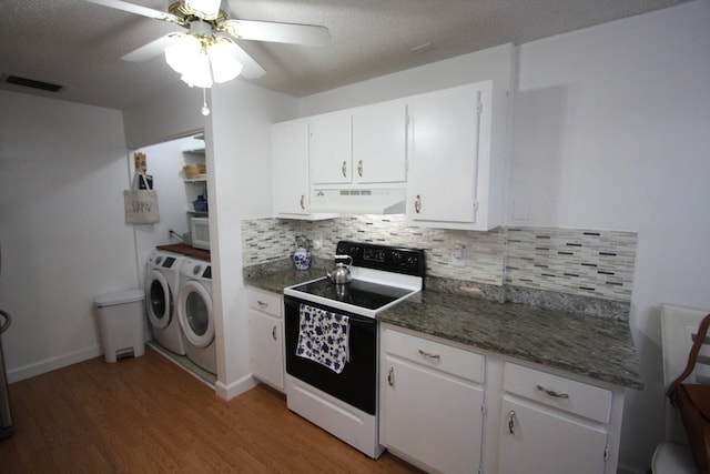 kitchen with hardwood / wood-style flooring, backsplash, white cabinets, washing machine and clothes dryer, and electric range