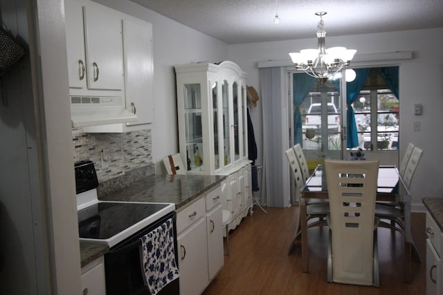 kitchen with decorative light fixtures, white cabinetry, decorative backsplash, dark hardwood / wood-style floors, and black electric range oven