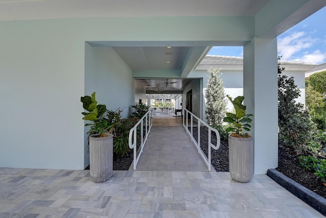 doorway to property featuring a patio and ceiling fan