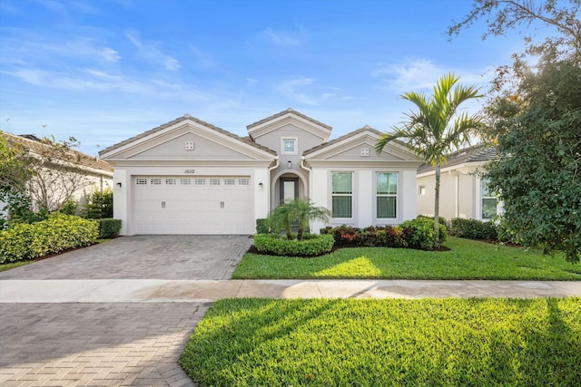 view of front of home featuring a garage and a front lawn