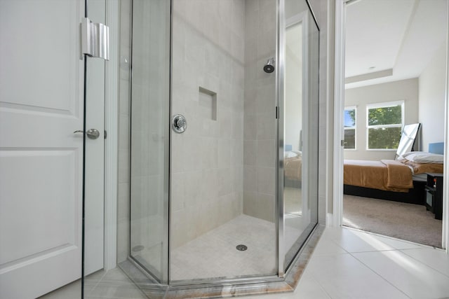 bathroom with a shower with shower door and tile patterned floors