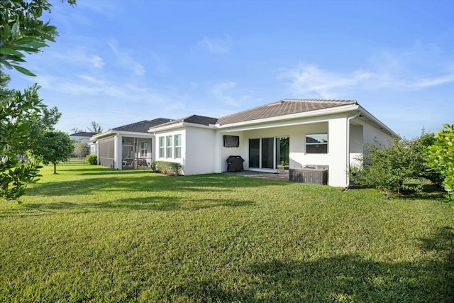 back of house featuring a sunroom and a yard