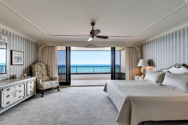 bedroom with a water view, access to outside, ornamental molding, ceiling fan, and carpet