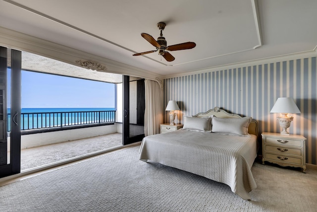 carpeted bedroom with crown molding, a water view, access to exterior, and ceiling fan