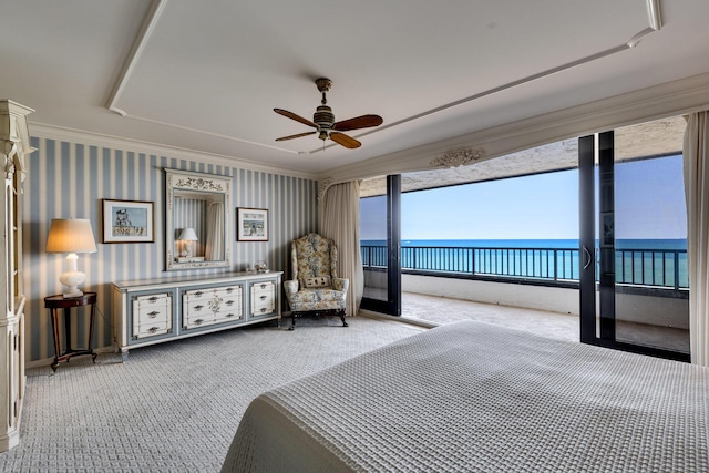 unfurnished bedroom featuring multiple windows, access to outside, light colored carpet, and a water view