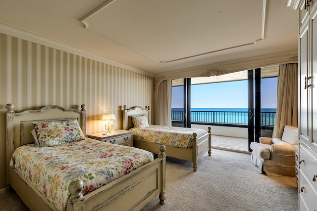 bedroom featuring crown molding, a water view, access to outside, and carpet