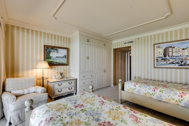 carpeted bedroom featuring ornamental molding and a closet