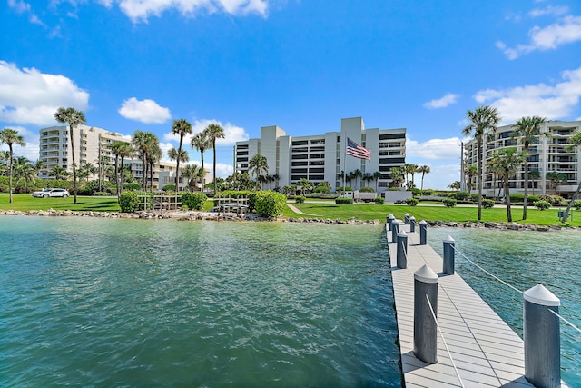 view of dock featuring a water view and a lawn