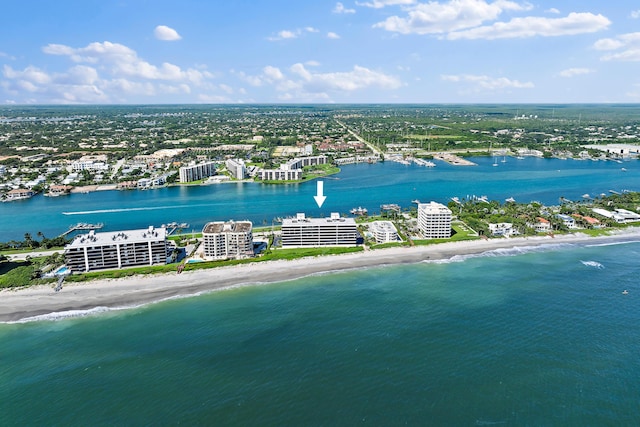 bird's eye view featuring a water view and a beach view