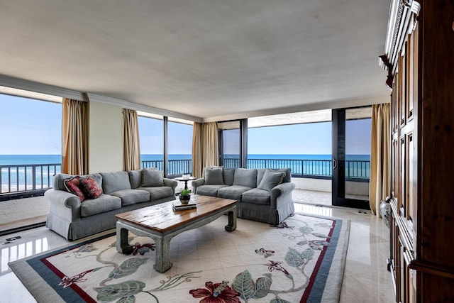 living room featuring a water view and a wall of windows