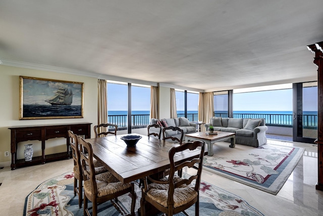 dining room with a water view, ornamental molding, and light tile patterned floors