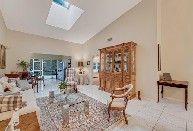 tiled living room featuring a skylight and high vaulted ceiling