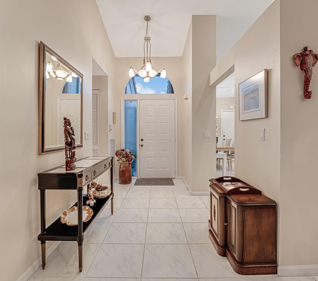 entrance foyer with high vaulted ceiling and a notable chandelier