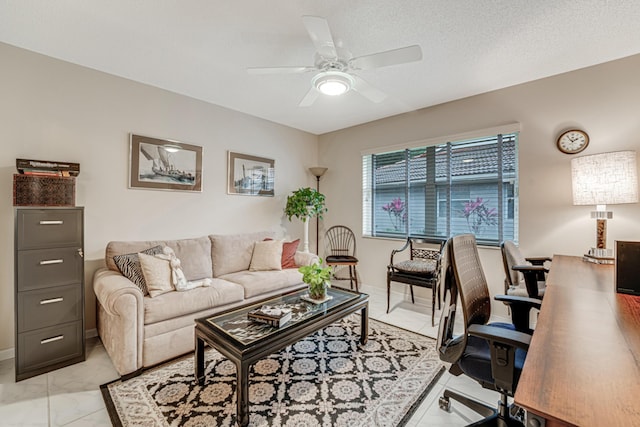 living room with ceiling fan and a textured ceiling