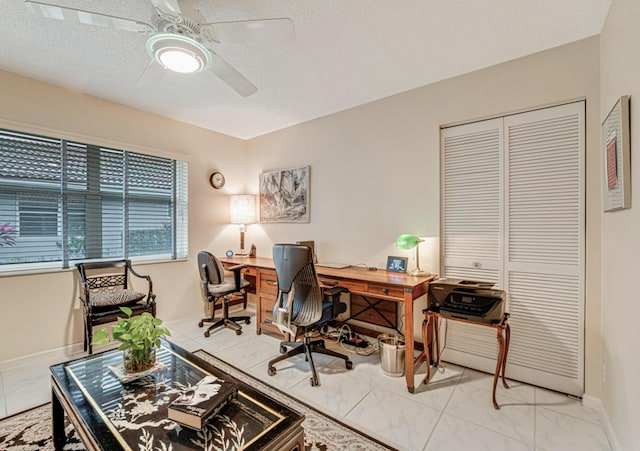 office with ceiling fan and a textured ceiling