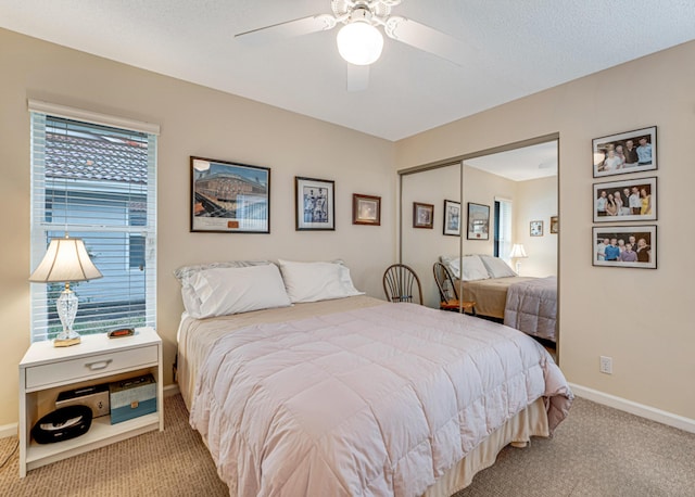 carpeted bedroom with a closet, multiple windows, and ceiling fan