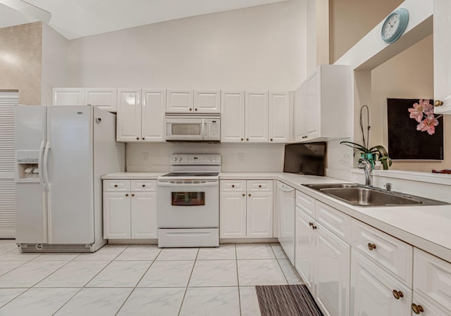 kitchen featuring high vaulted ceiling, sink, white appliances, and white cabinets