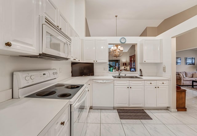 kitchen featuring decorative light fixtures, white appliances, vaulted ceiling, white cabinets, and sink