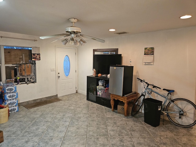 foyer with ceiling fan and tile patterned flooring