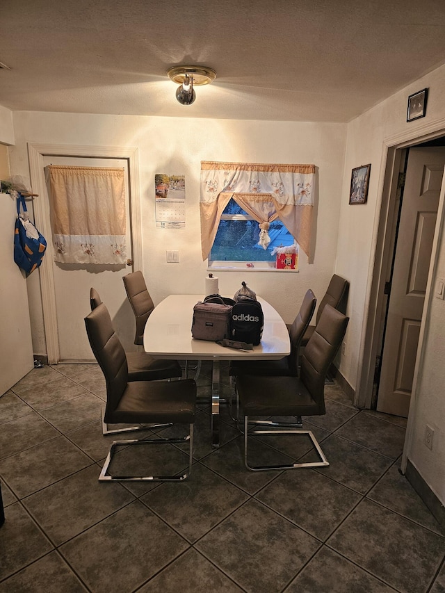 dining area with dark tile patterned flooring