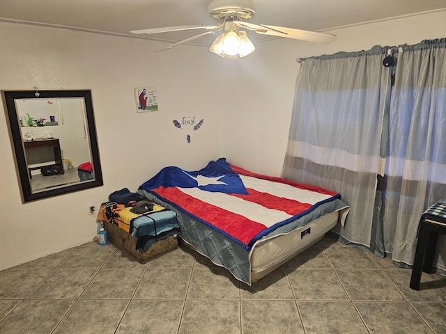 bedroom with ceiling fan and tile patterned floors