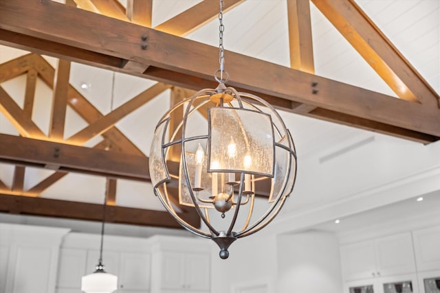 interior details with beam ceiling and a chandelier